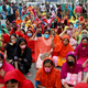 Garments workers in Dhaka shout slogans as they block a road demanding their due wages